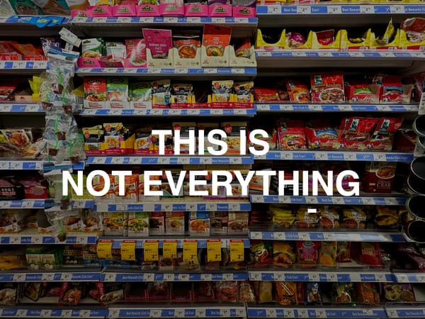 a supermarket aisle displaying southeast-asian sauces; the words 'THIS IS NOT EVERYTHING' in white